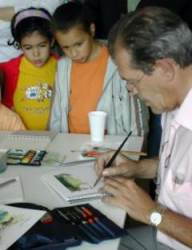 Juan Carmaniu creando una obra ante la vista de los asistentes